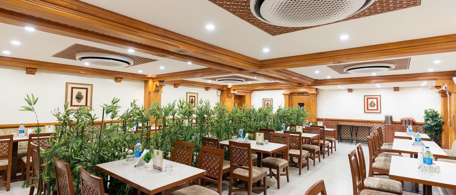 Seating arrangement in restaurant at Hotel Pai Vista, Mysore