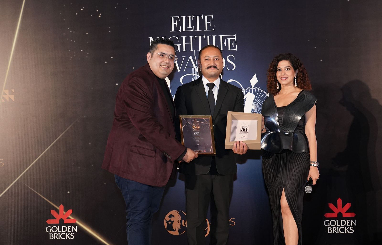 Three individuals with awards posing for photo Elite nightlife award at The Claridges New Delhi - Claridges Collection