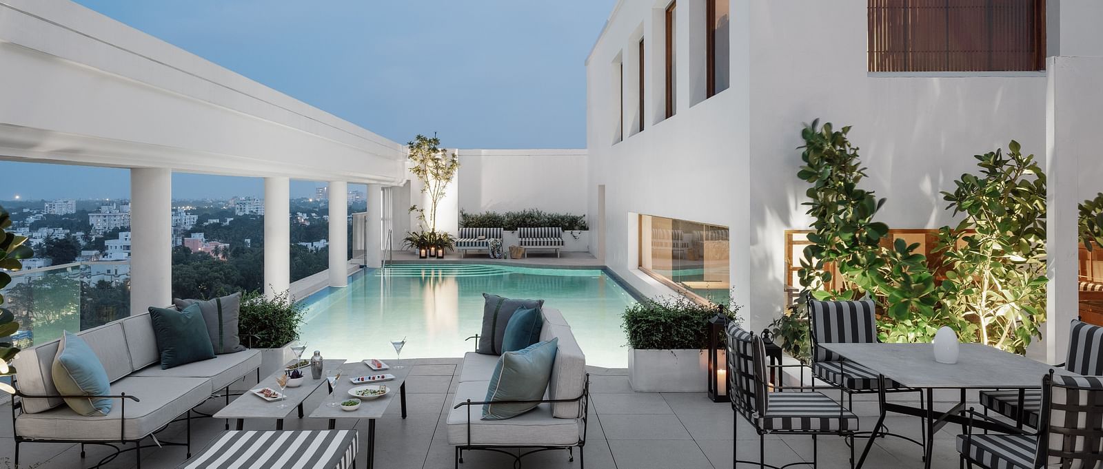 Image of a Swimming pool  with chairs and tables on the side at The Raintree St.. Mary s Road