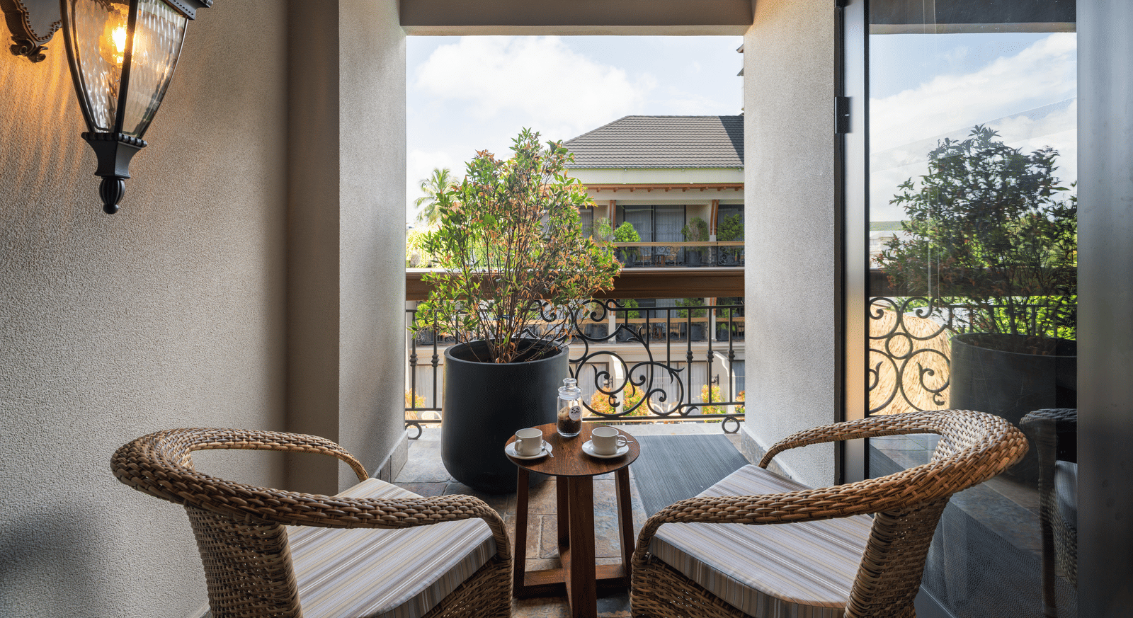 2 arm chairs kept on the balcony of the Executive Room along with a small coffee table at The Evren, Vagator.