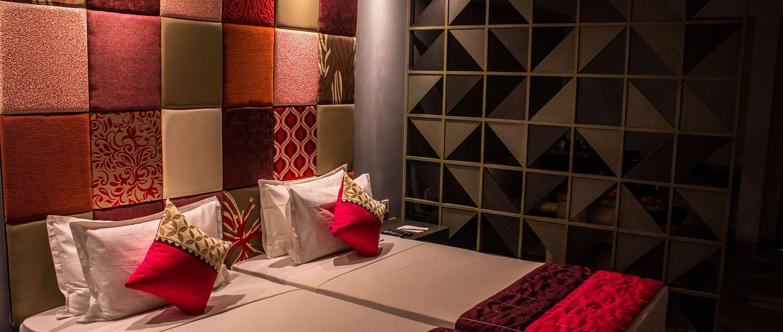A room with twin beds and  pillows arranged on it  | Regency Tirunelveli By GRT Hotels