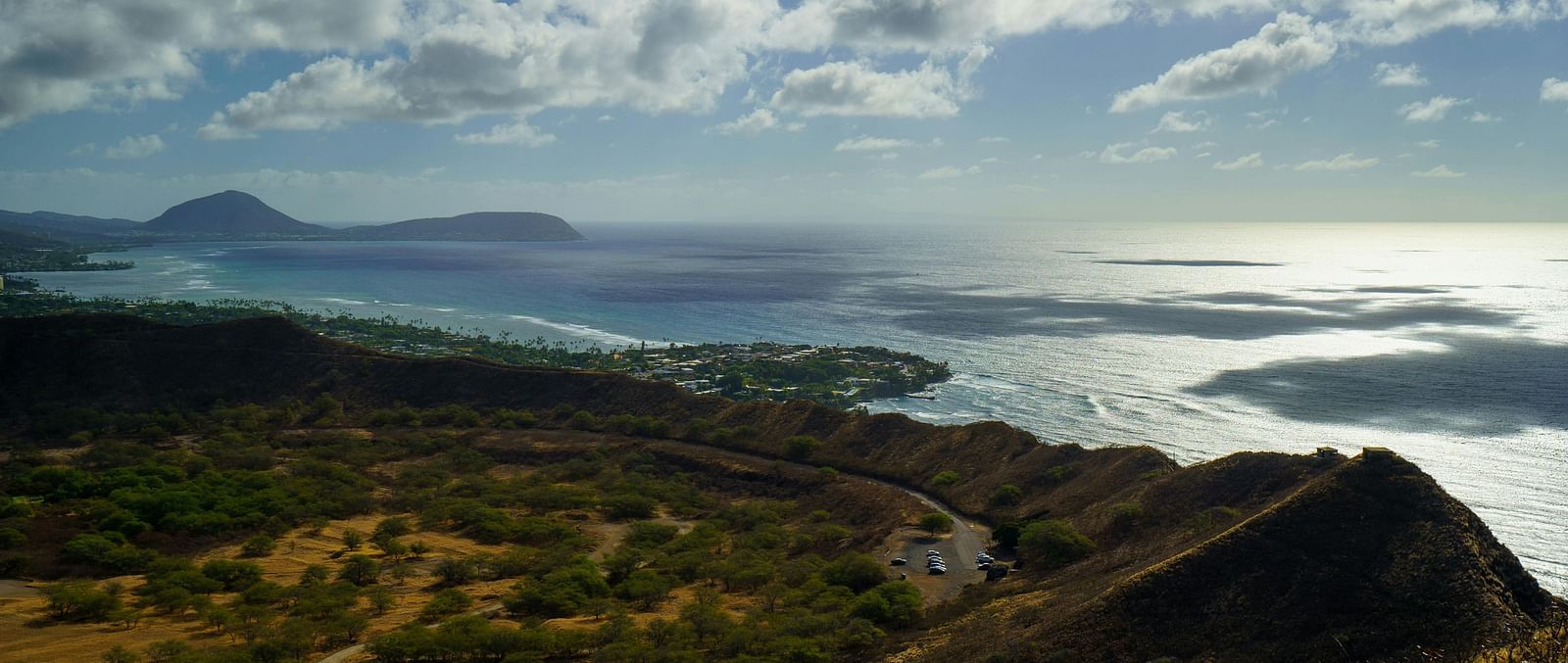 A serene view of a cliff near a water body on a cloudy day