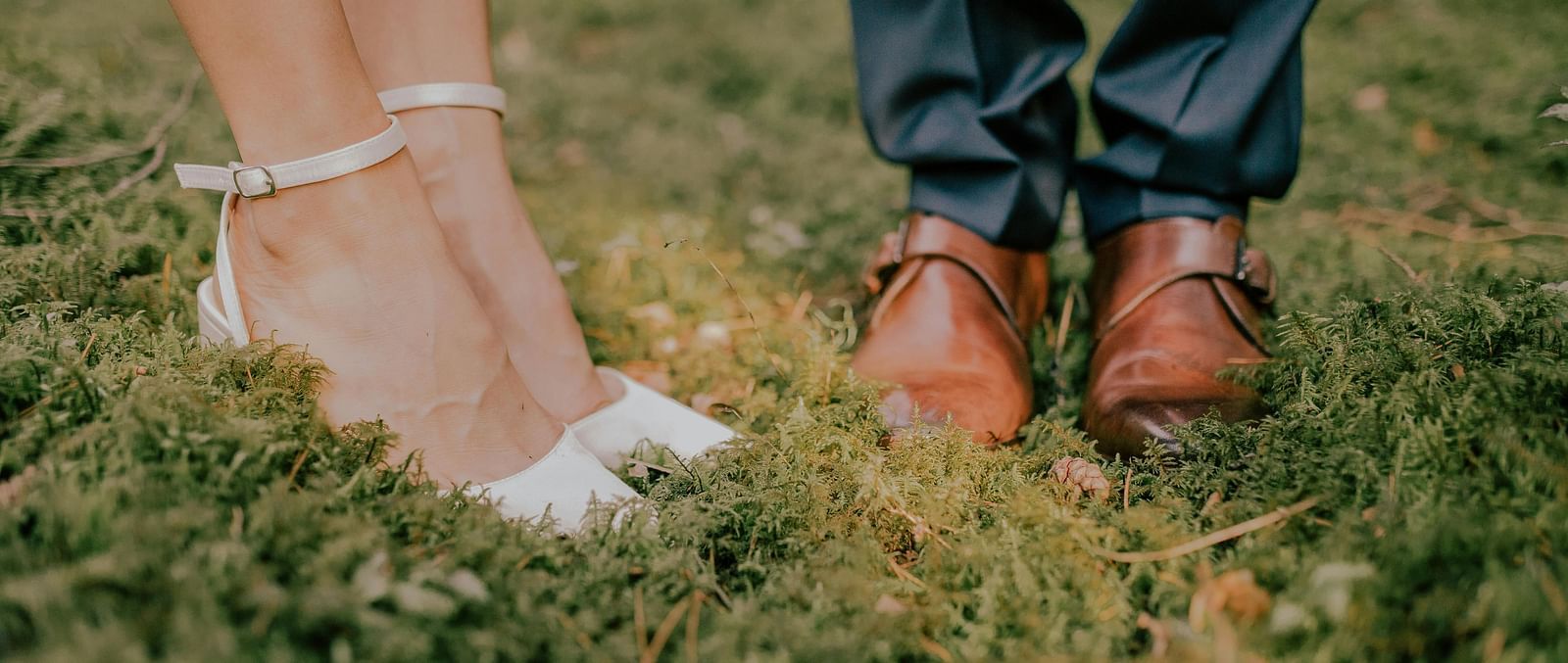 A view of feet of a couple getting married in the wedding attires - Narrow Gauge Inn - A Serenite Hotel Near Fish Camp.