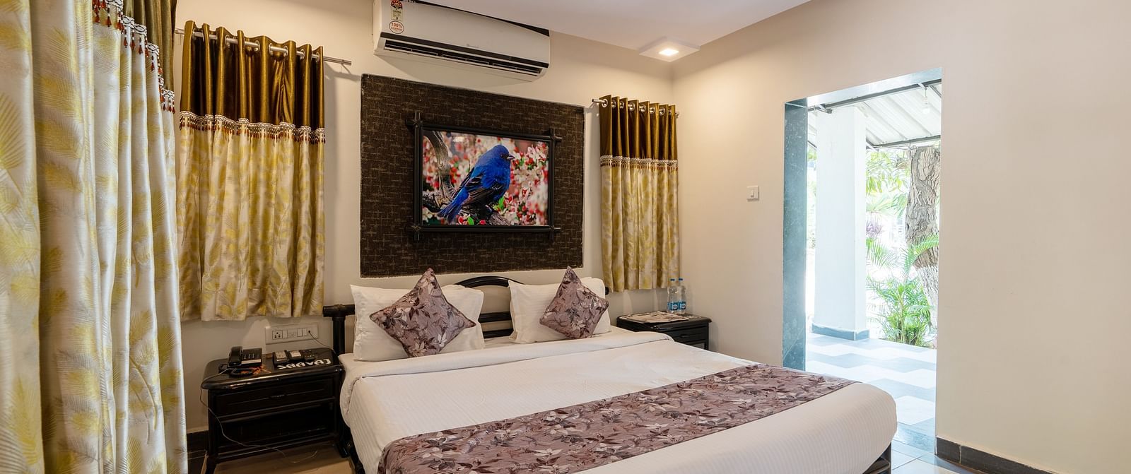 A room with with a double bed and side tables at Saavaj Resort