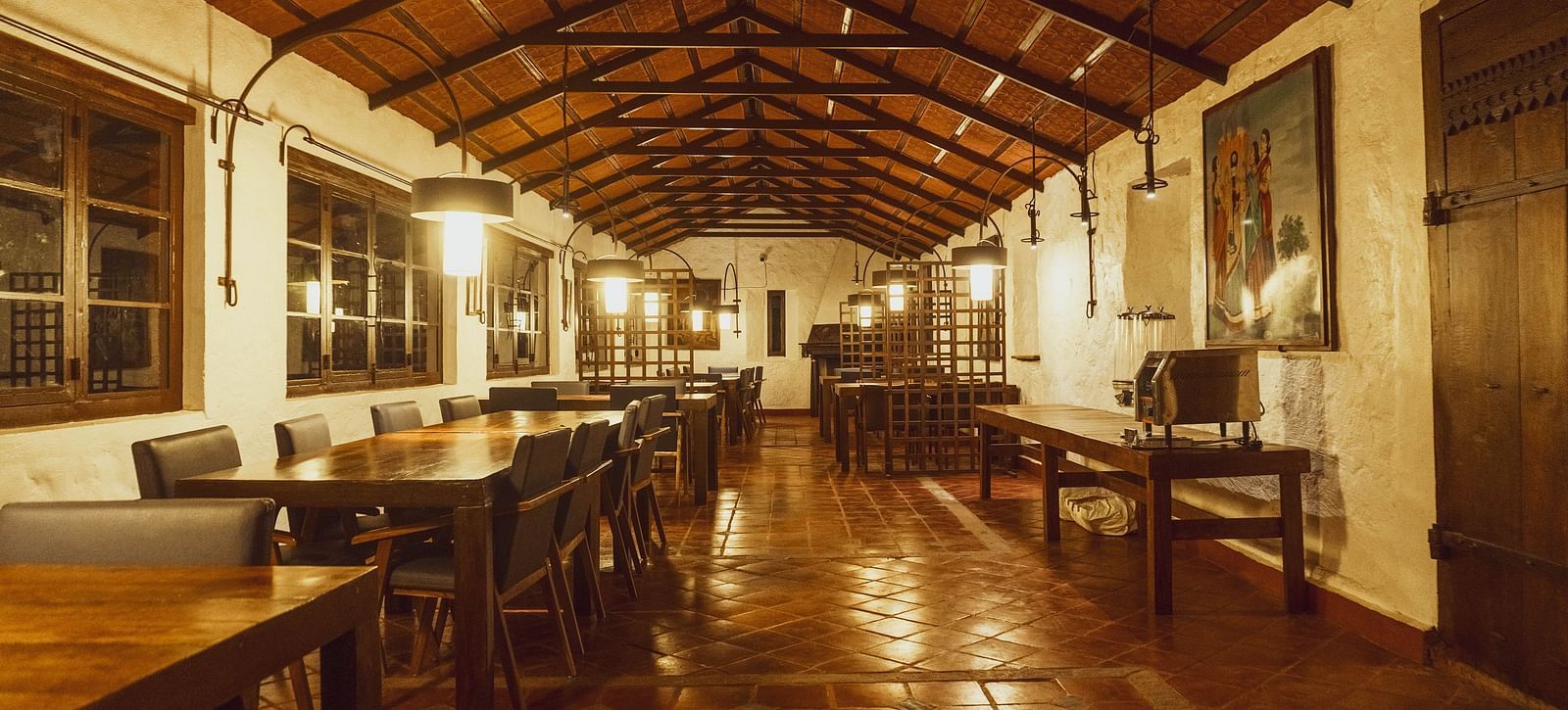 Warmly lit dining hall with wooden interior  | Mango Hill, Yercaud