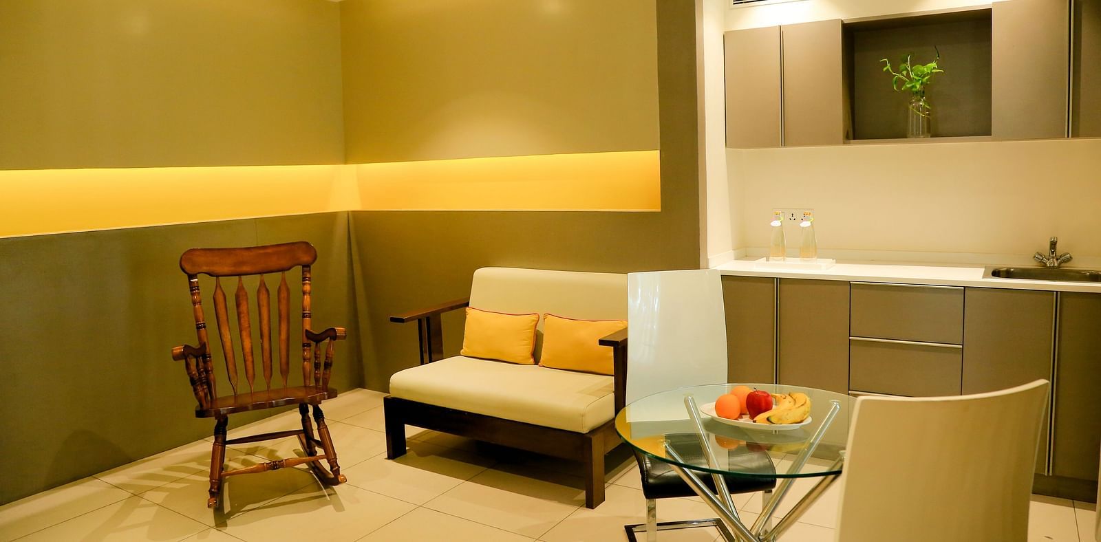 Furniture is arranged around the room, with warm lighting set up to create a cosy atmosphere