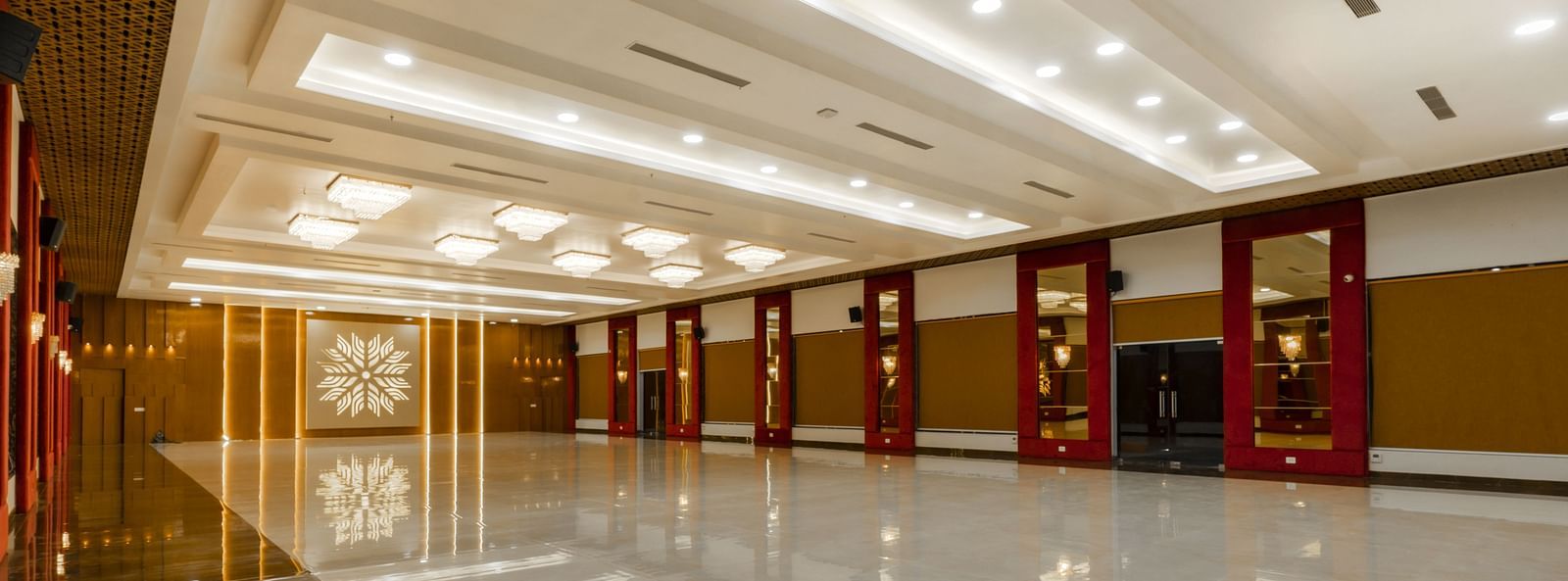 An angular shot of a long, empty hallway with a highly polished floor reflecting the ceiling and walls - Bamboo Saa Mulberry Resort, Pushkar