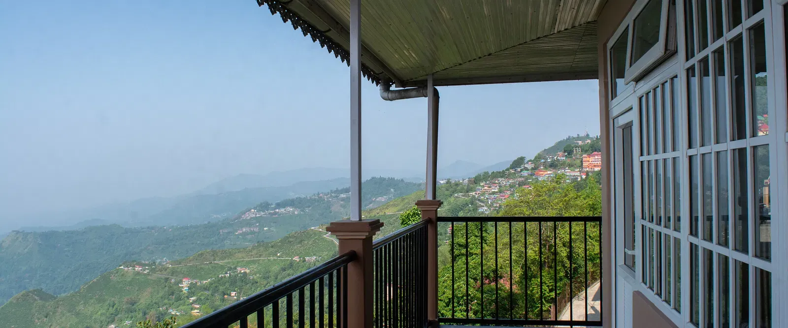  Mountain-facing balcony with iron railing and scenic valley views at Avianna Windy House Wellness Retreat & Spa.
