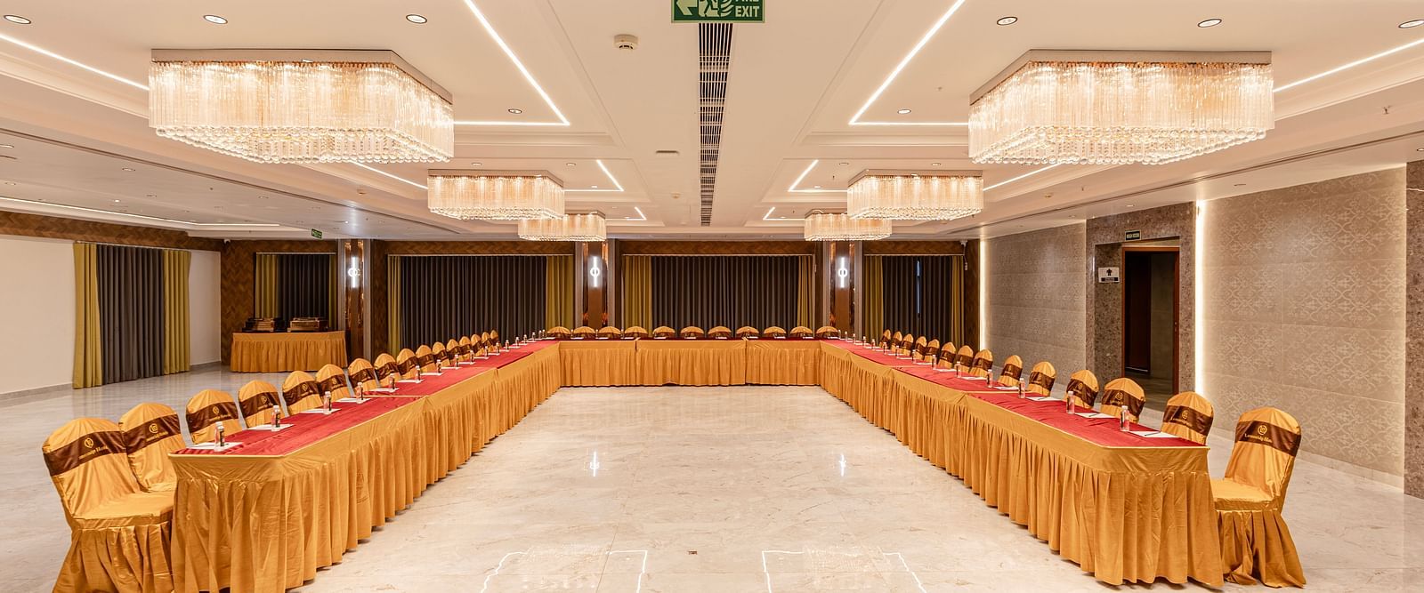 Long table U style event seating in banquet hall at Lemonridge Hotels, IDPL Balanagar.