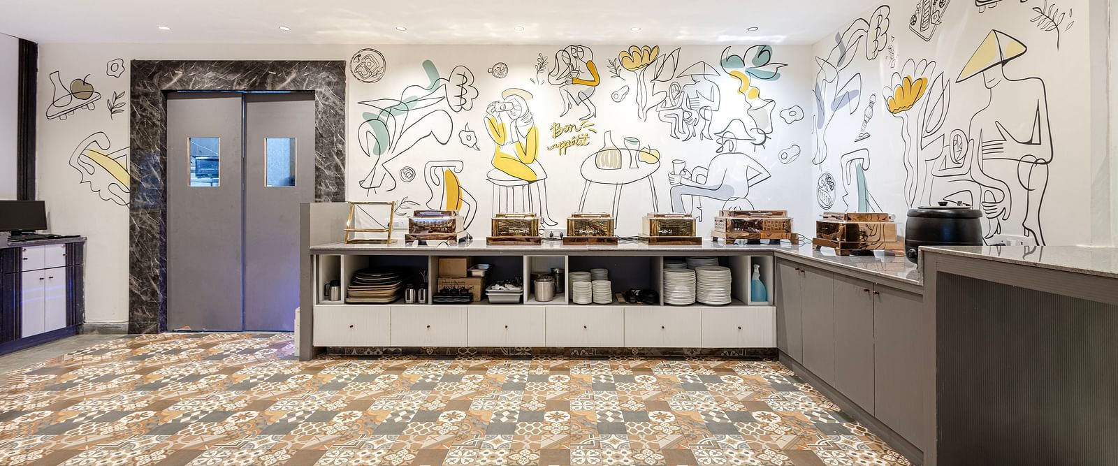 Restaurant reception area with artistic wall mural at Lemonridge Hotels, IDPL Balanagar