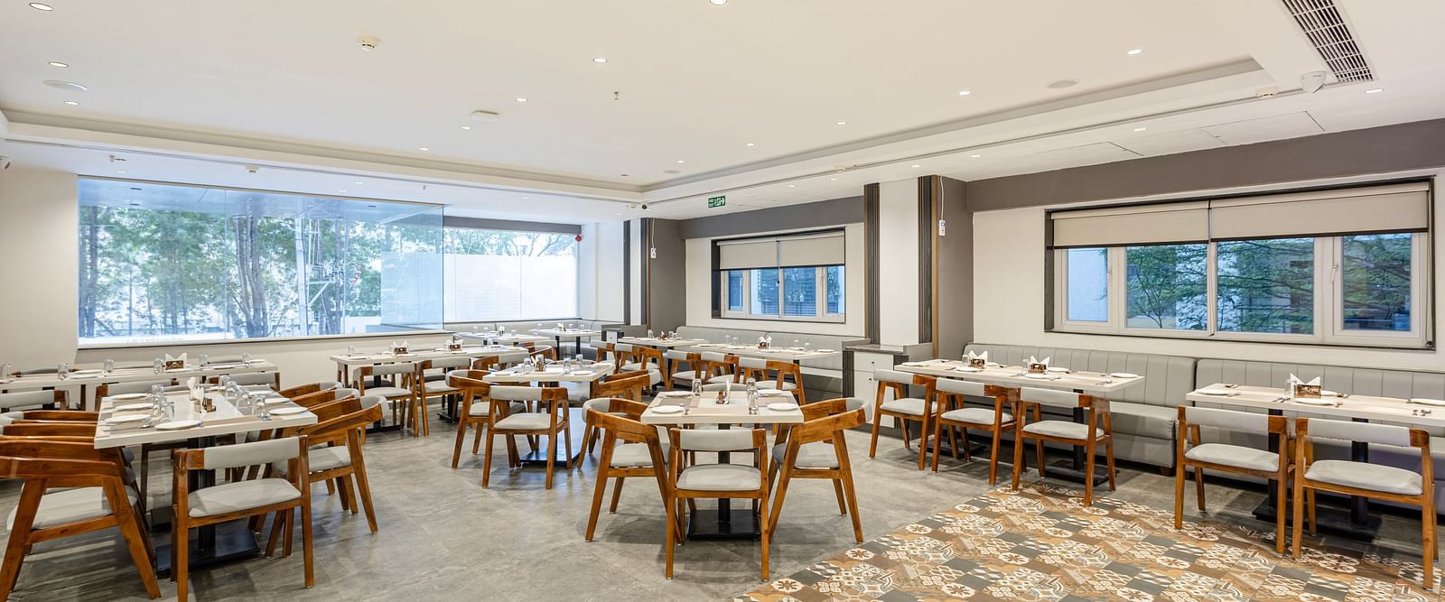 Wide-angle view of the elegant dining space with patterned flooring at Lemonridge Hotels, IDPL Balanagar.