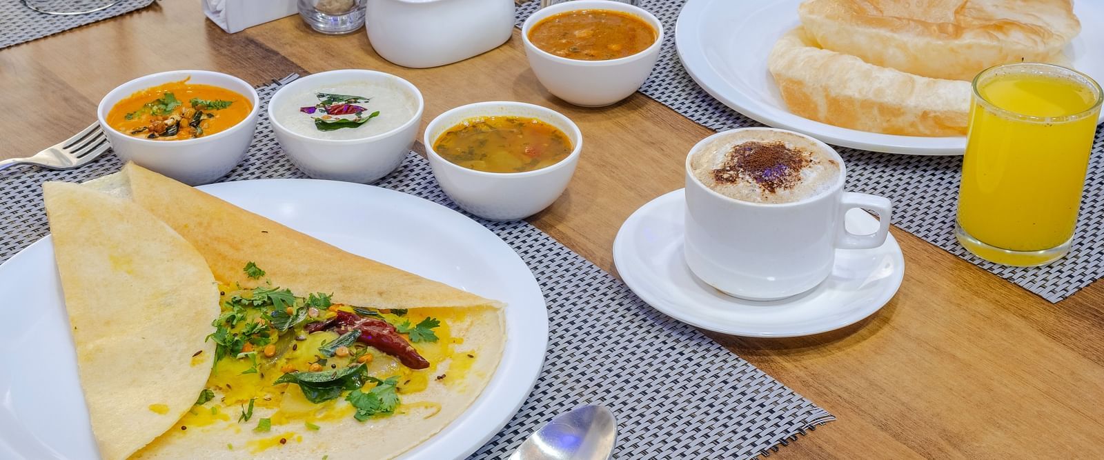 Plate on a table filled with breakfast, coffee and juice at Lemonridge Hotel.