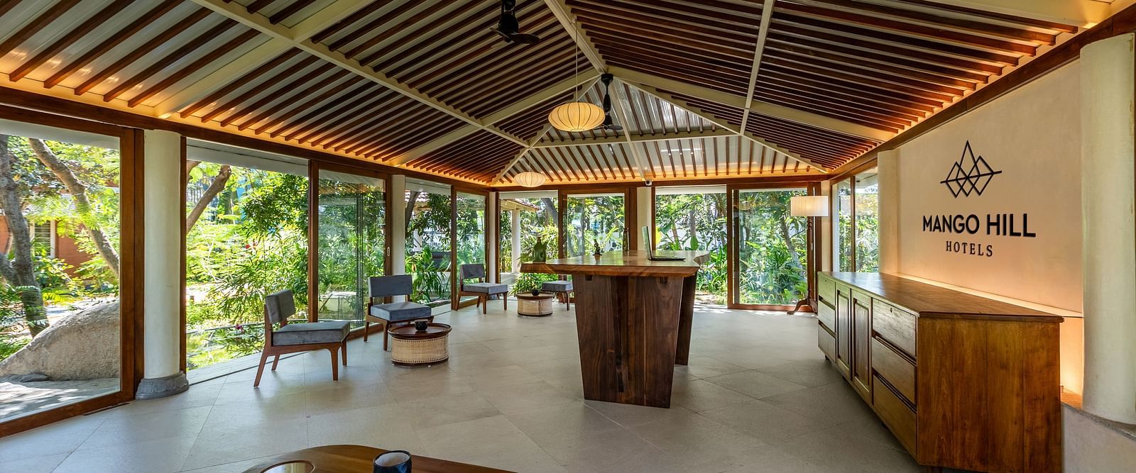 Open-air lounge area with comfortable seating and a high, intricately designed ceiling | Mango Hill Shallow Beach Resort ECR