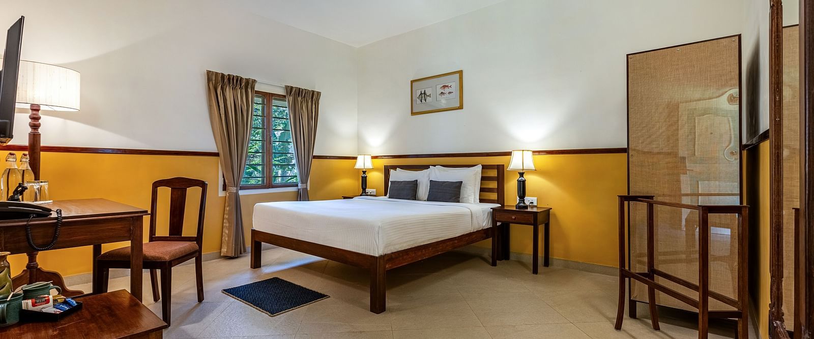 omfortable hotel room near Pondicherry with a double bed, desk, and seating area | Mango Hill Shallow Beach Resort ECR
