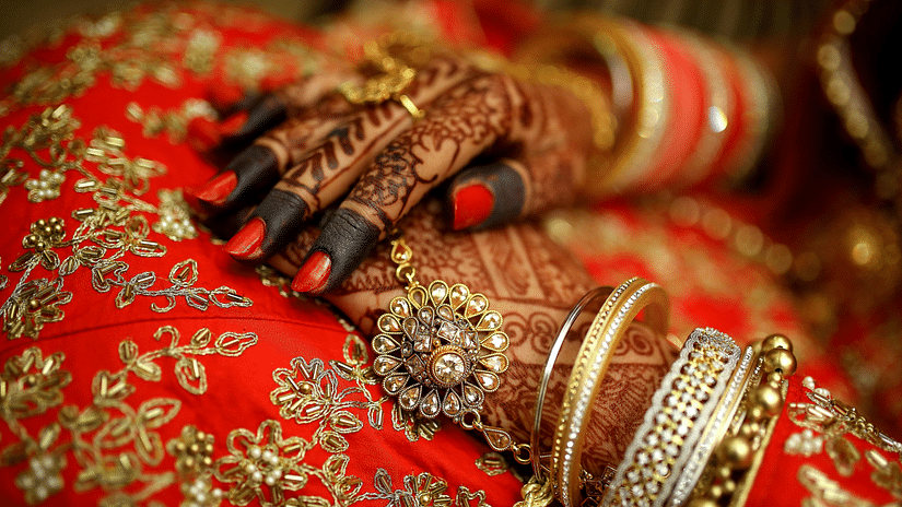 a close up shot of a Bride wearing traditional bangles and rings