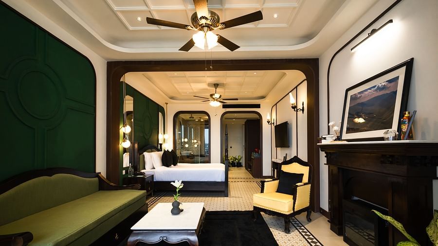 An image of a bedroom with king size bed, flat TV screen, chair, and sofa - Polo Orchid Resort, Cherrapunjee