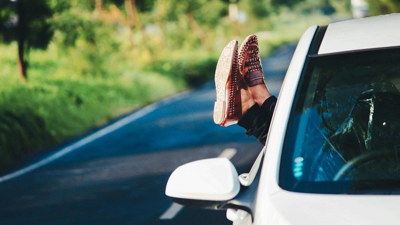 legs hanging out from car window 