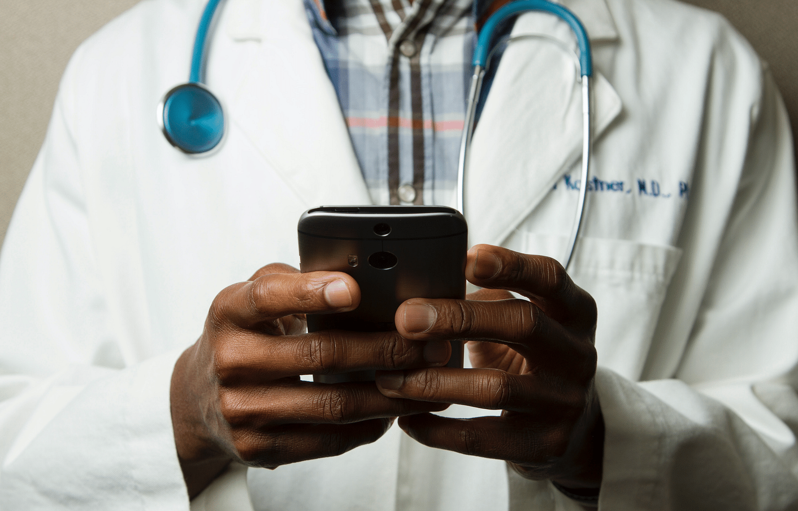 A picture of a doctor holding a phone