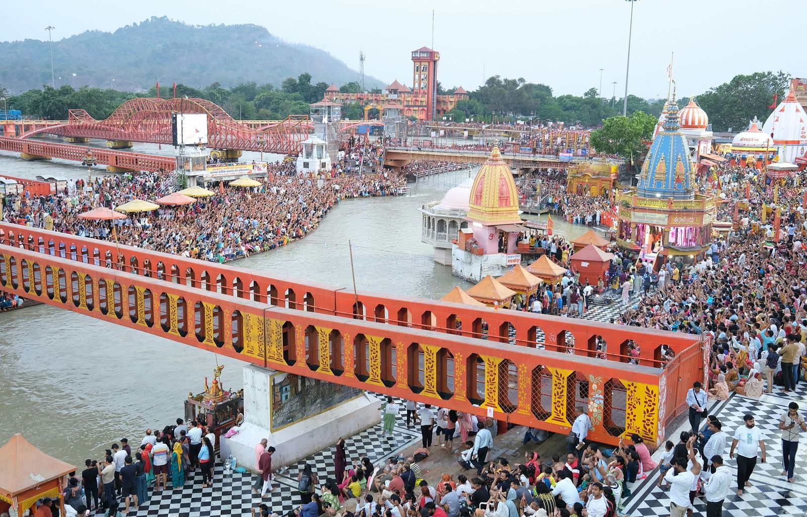 An image of religious place which has temples and devotees gathered around