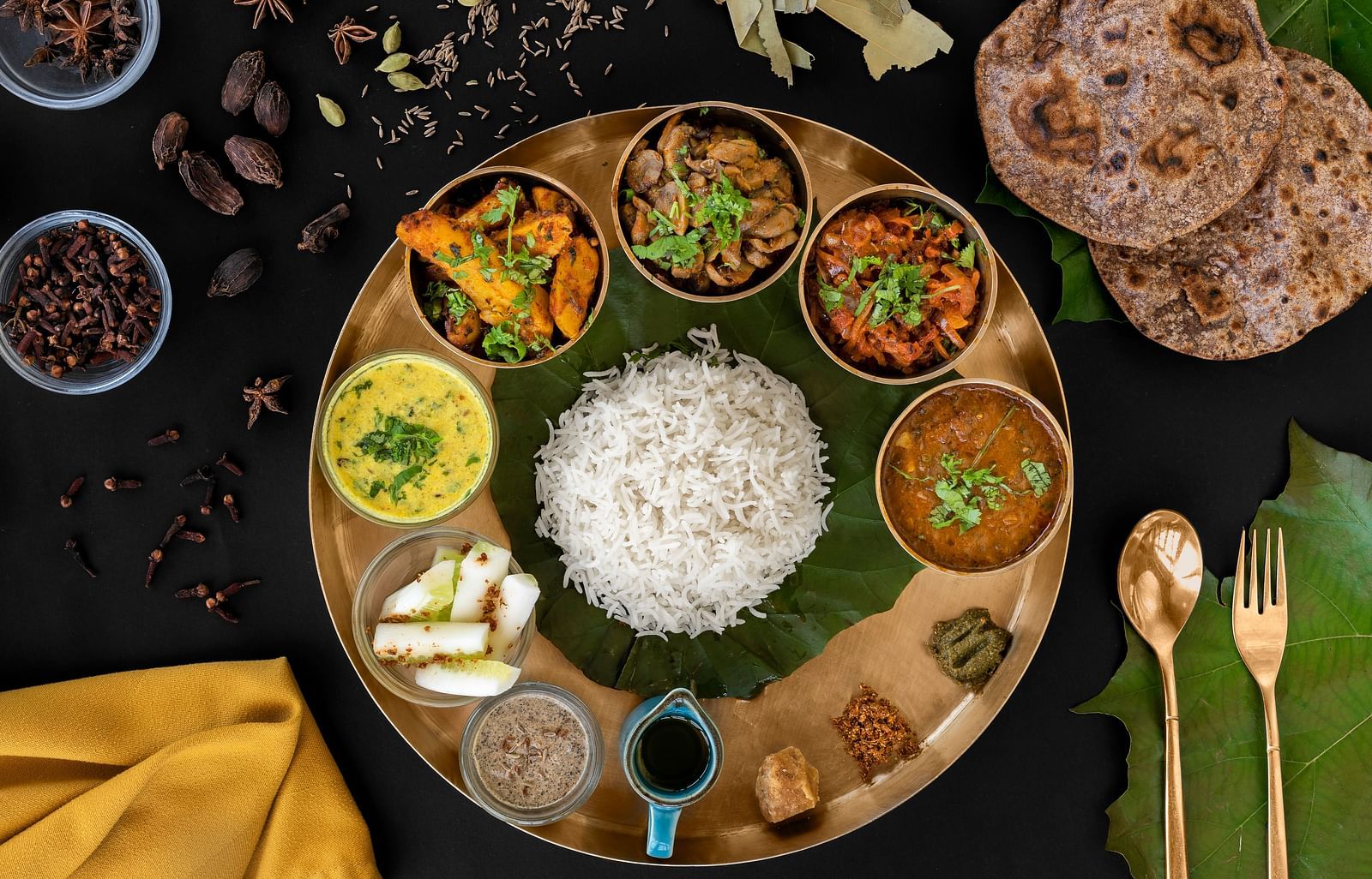Authentic North Indian thali at The Patio in Haridwar with rice, chapati, and assorted vegetarian curries.