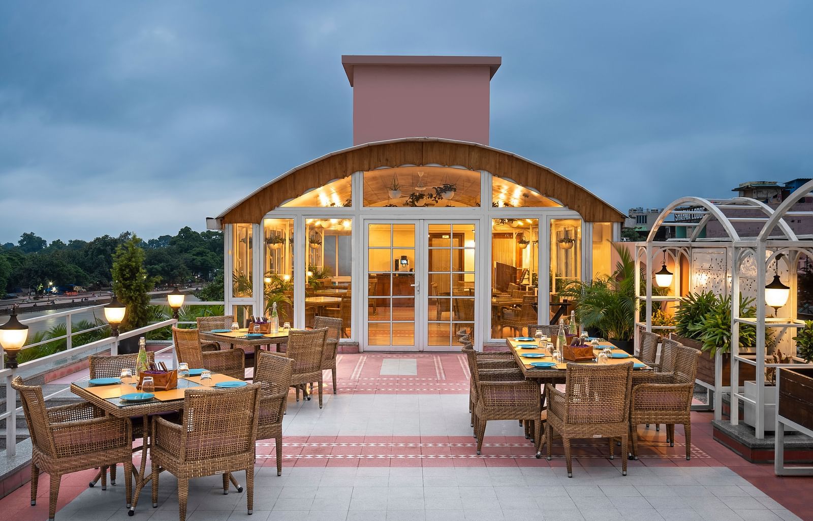 Rooftop entrance of The Patio café at Ganga Lahari, Haridwar with panoramic river views and elegant seating.