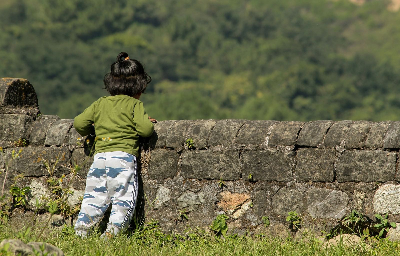 A kid peeping out from a fort