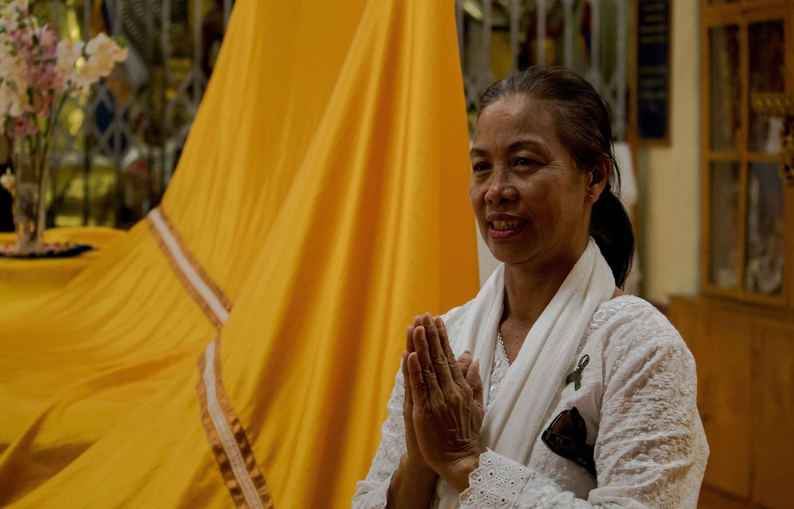 An image of a woman greeting with folded hands