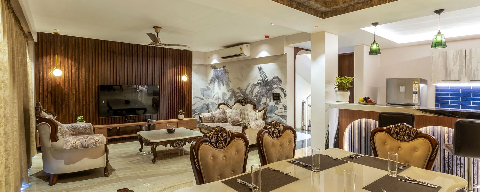the living room with sofas and a dining table inside one of the rooms - The Tanisi Hotels & Resorts, Goa