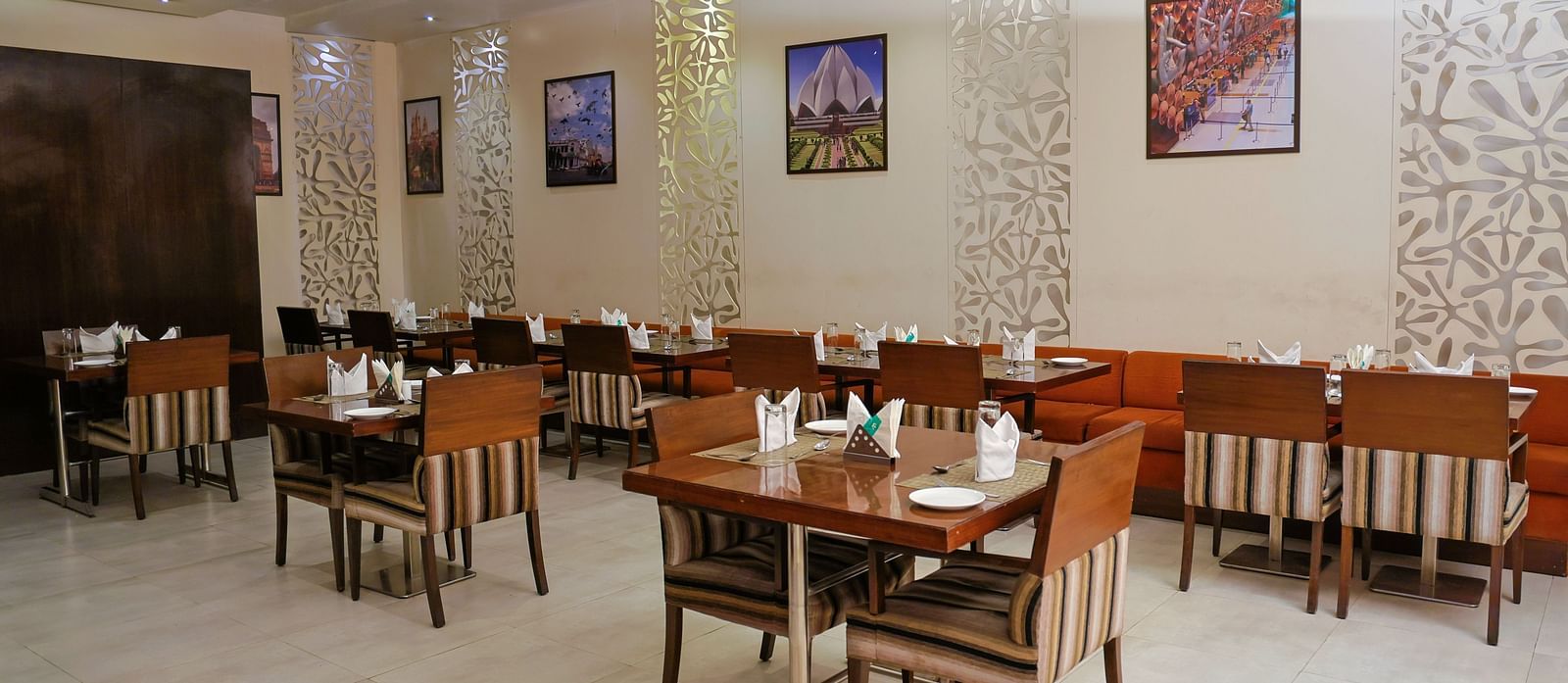The wooden tables and chairs are arranged in groups of four, with all the culinary dishes laid out on the tables