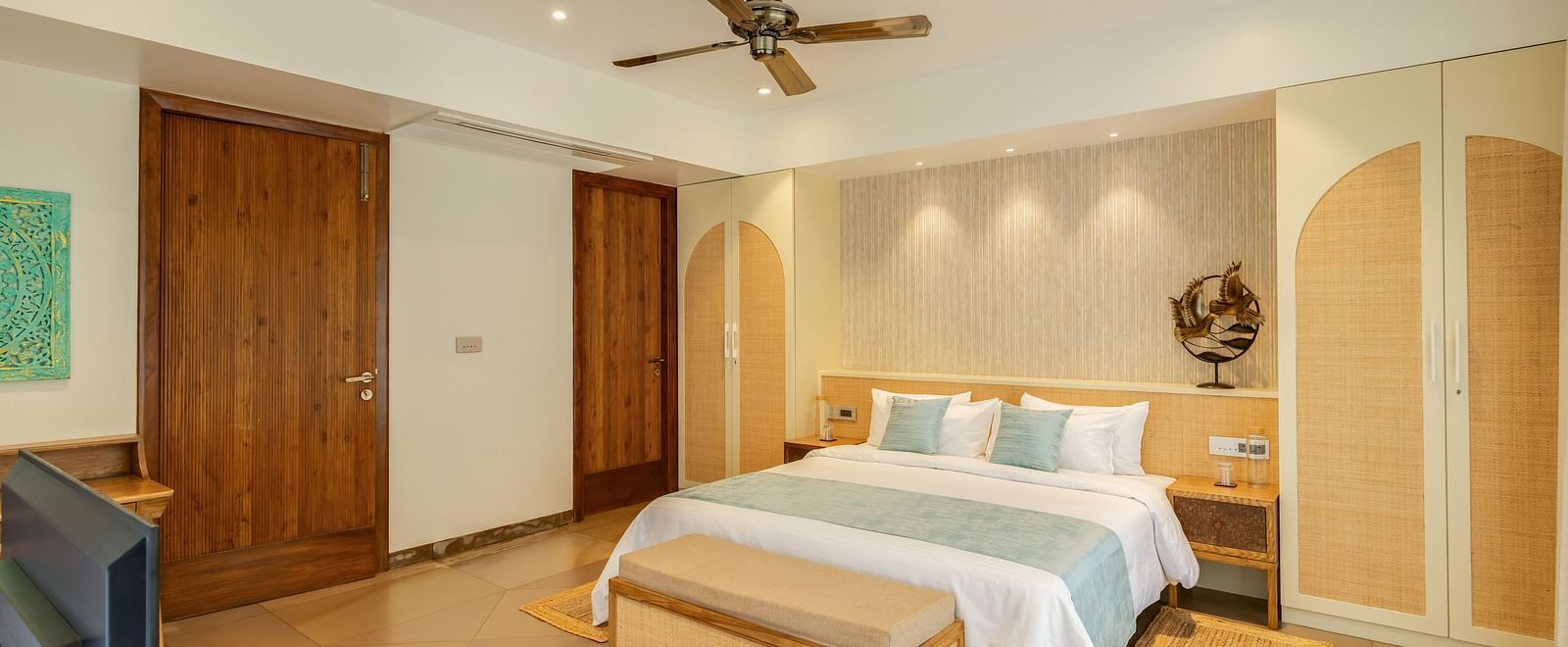 A spacious bedroom with a king-sized bed, wooden furnishings, and warm lighting  - BluSalzz Villas - Alocassia, Anjuna