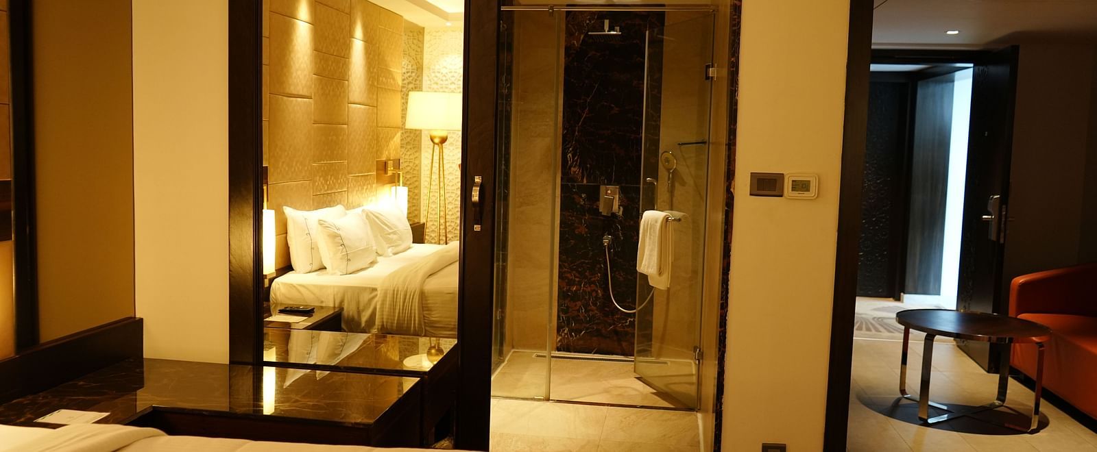 A view of the room featuring a bed and a separate living area with a sofa and table at Cenneys Gateway.