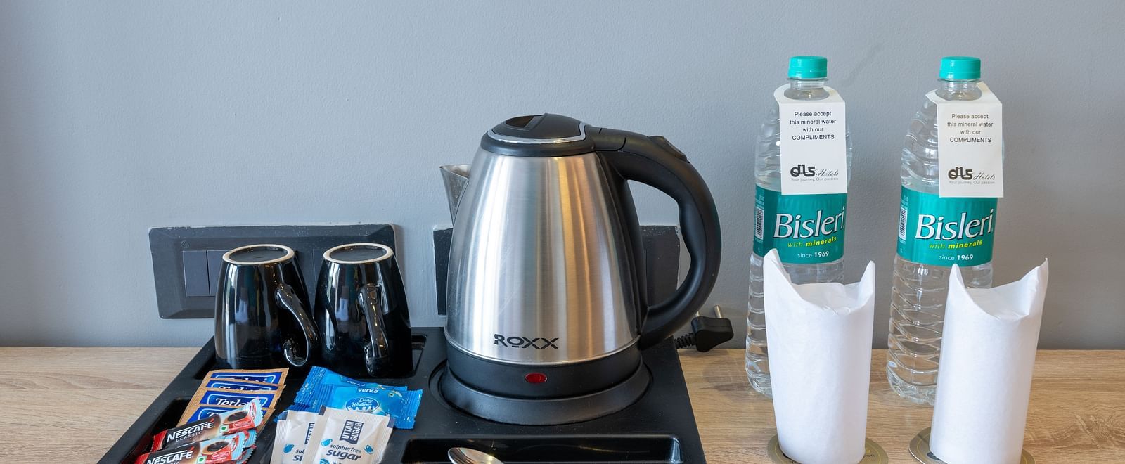 In-room tea and coffee setup with kettle, cups, and bottled water - DLS Forest Vines Resort & Spa, Ramnagar (Jim Corbett)