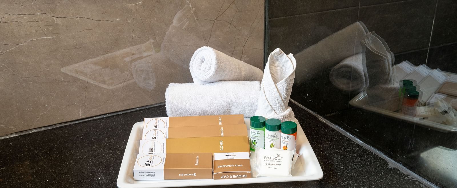 Tray with towels, tissues, and toiletries on a bathroom counter - DLS Forest Vines Resort & Spa, Ramnagar (Jim Corbett)