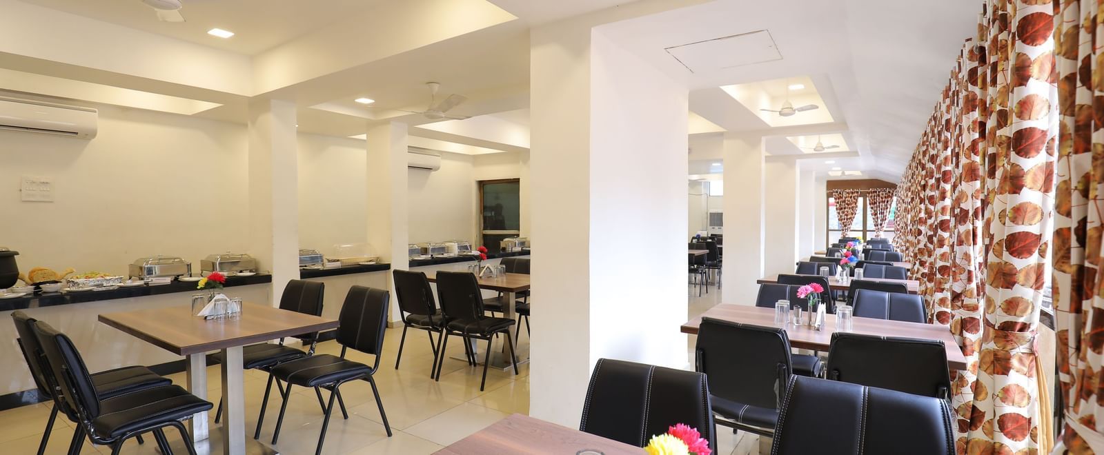Extended view of the seating area in the Darbar Restaurant at Highland Resort.
