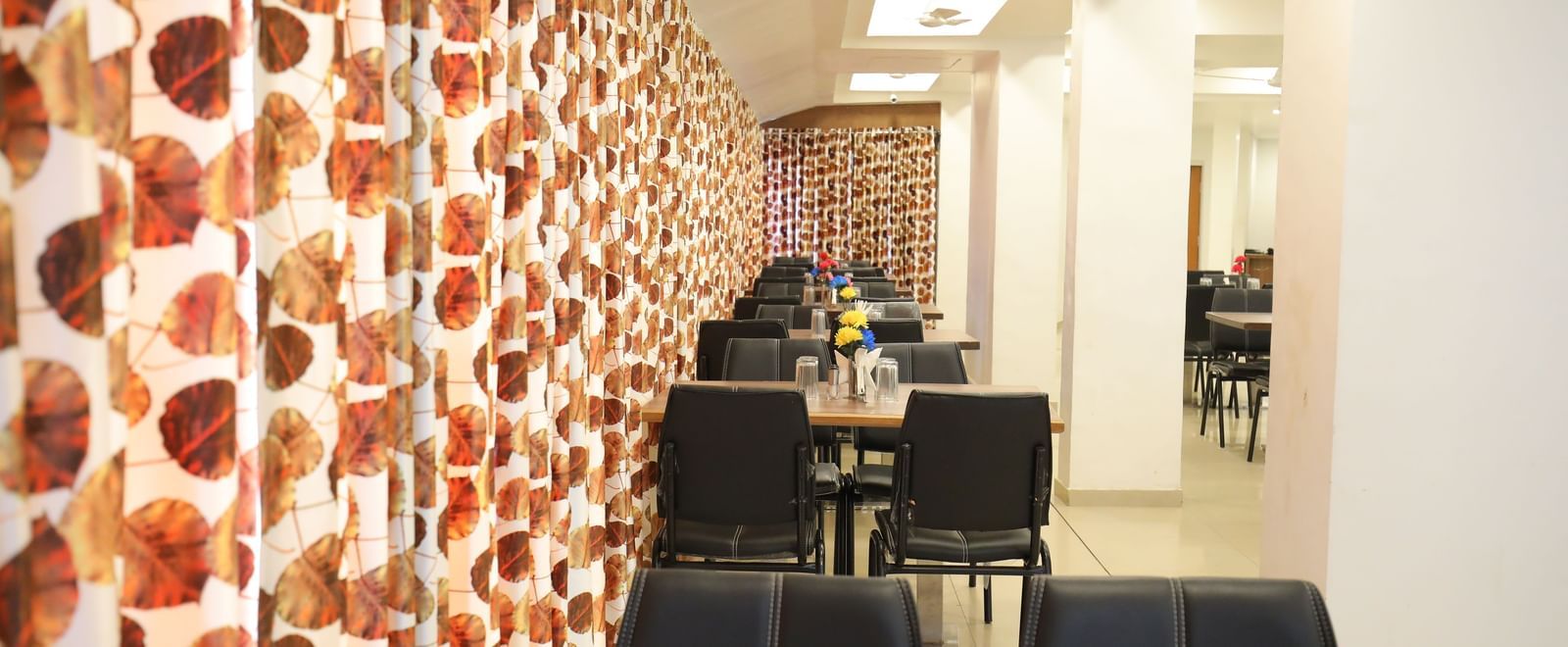 A row of dining tables neatly arranged at the Darbar Restaurant in Highland Restaurant.