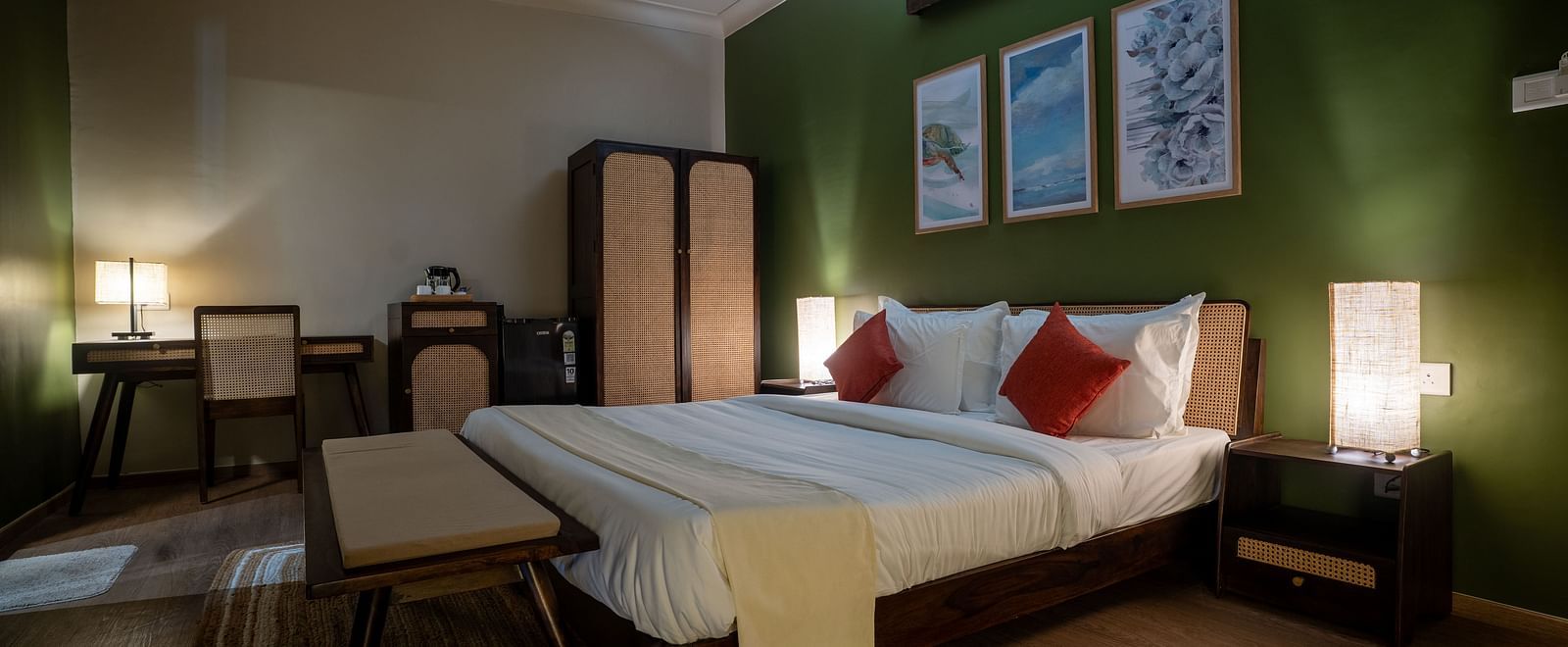Well-lit bedroom with green accent wall, cosy furnishings, and twin beds at Kssemya.