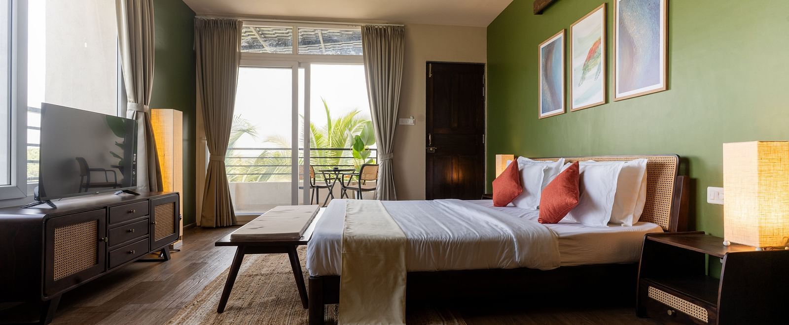 Spacious bedroom with natural lighting, modern decor, and a cosy seating area at Kssemya.