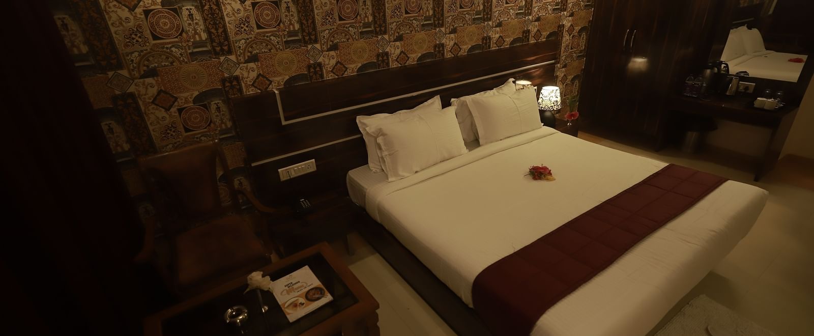 A Deluxe Room of Mountview Resort furnished with a king size bed, a wardrobe, bedside tables, and a seating area.