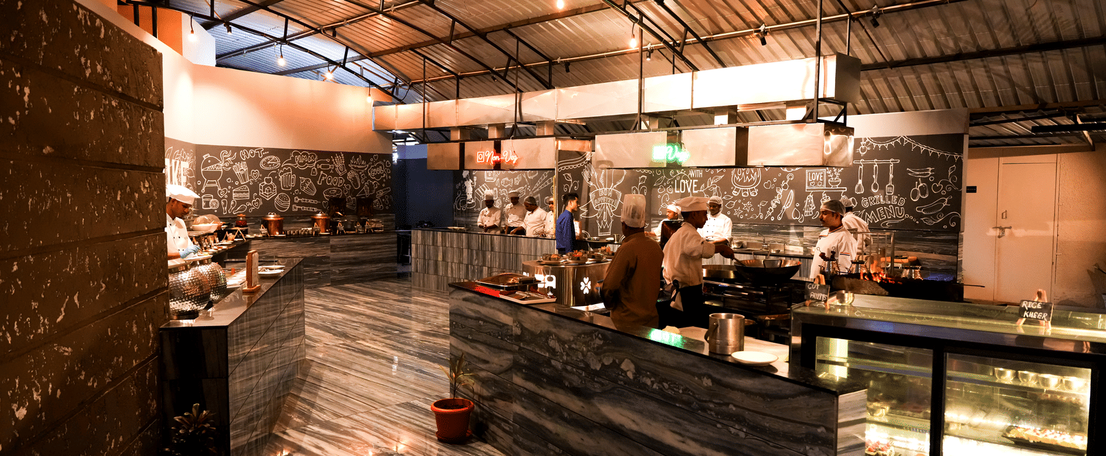 Restaurant buffet counter with “Fire & Smoke” sign at Pravasa Hotel, Kolhapur.