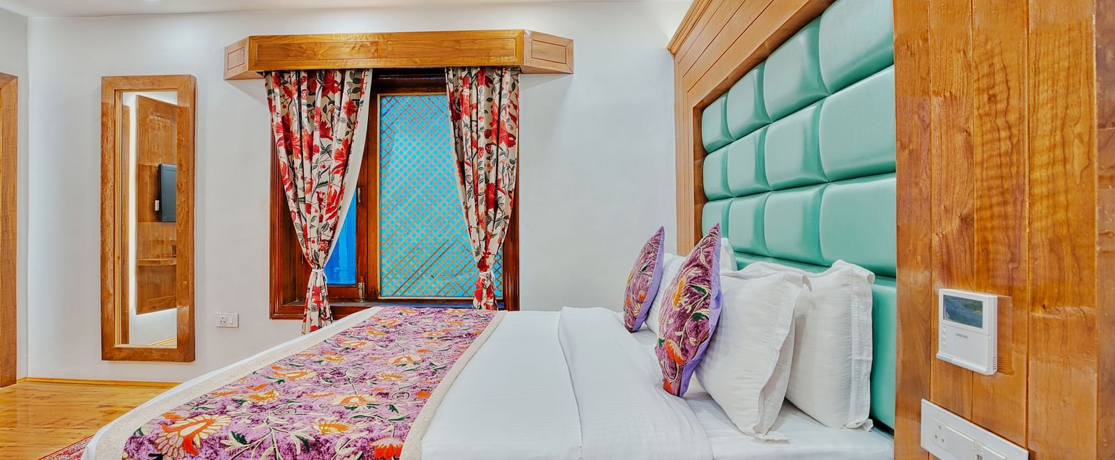 Stylish twin bed setup with bright curtains and a cosy atmosphere at Royal Comfort Regency, ideal for a peaceful escape.