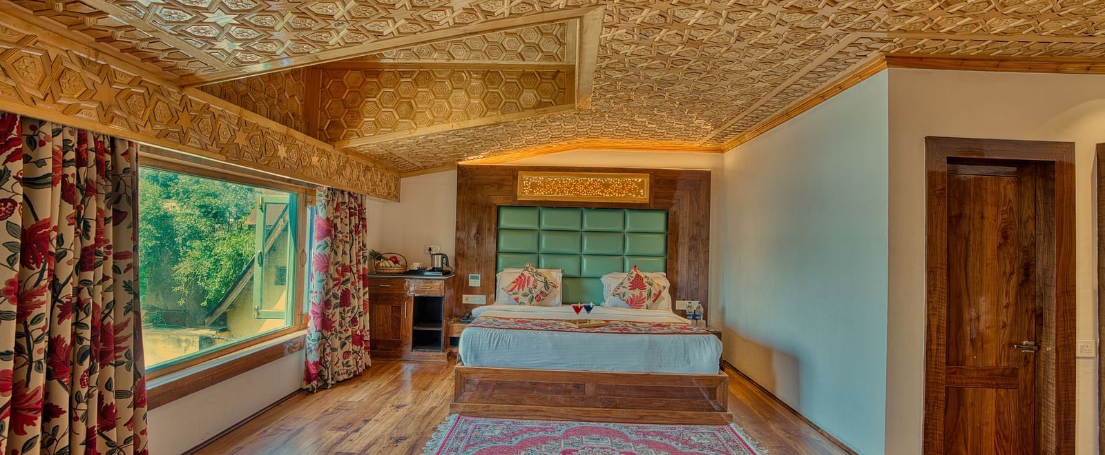 Cosy bedroom with scenic window views and traditional decor at Royal Comfort Regency, perfect for a tranquil stay.