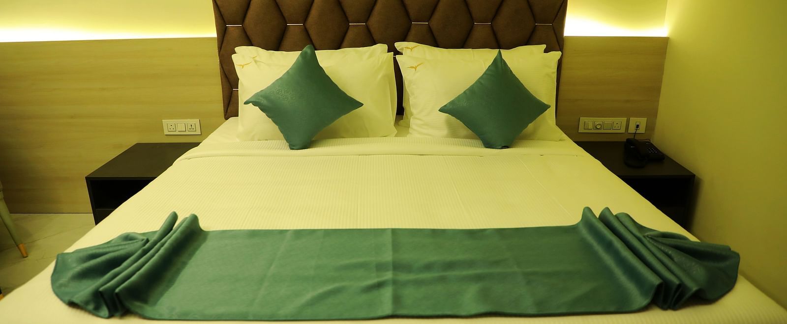 King-size luxury bedroom at Town Square Suites with contemporary decor and plush bedding