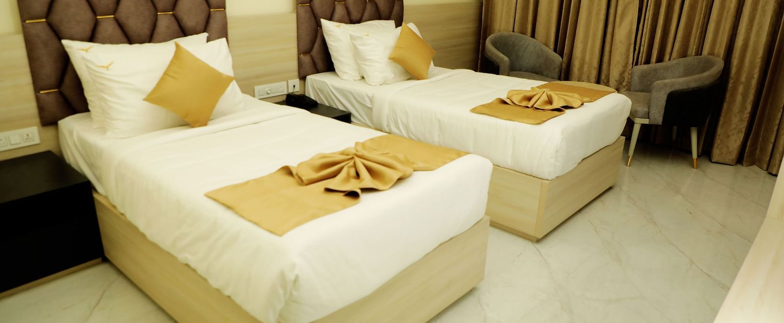 Twin bed deluxe room at Town Square Suites featuring elegant furnishings and cozy ambiance