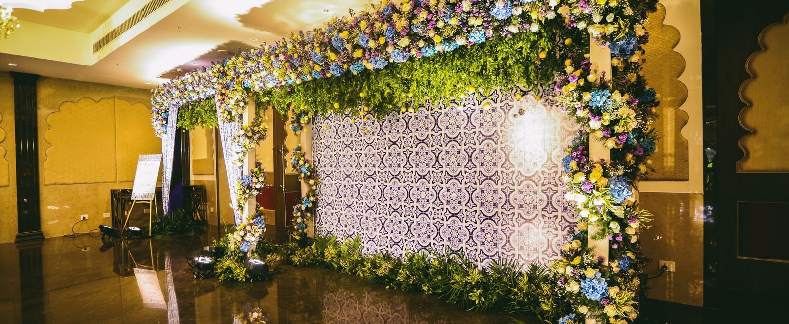 A stage featuring an arch of ornamental plants and lights perfect for pre-wedding photo shoots - Kaldan Samudhra Palace