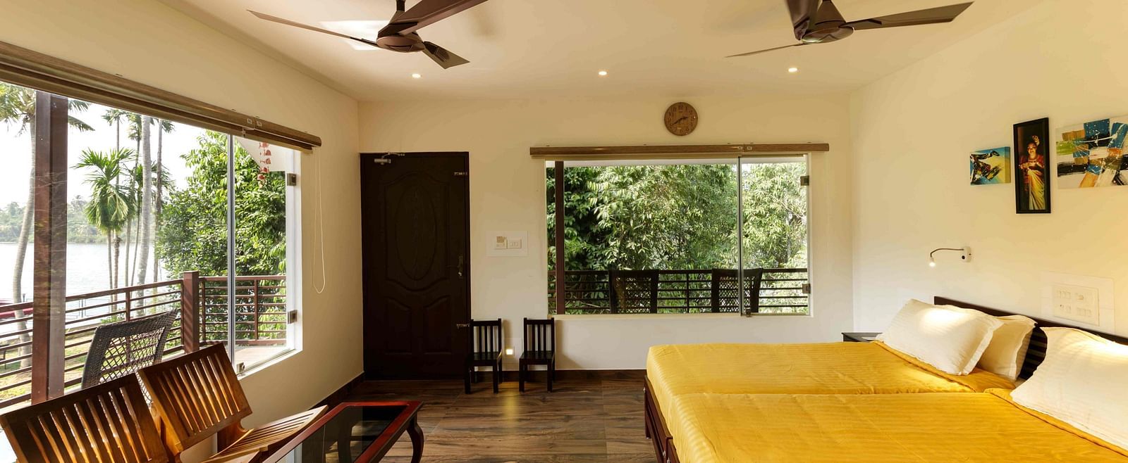 A bedroom with a bed, wooden furniture, and a view of the outside.