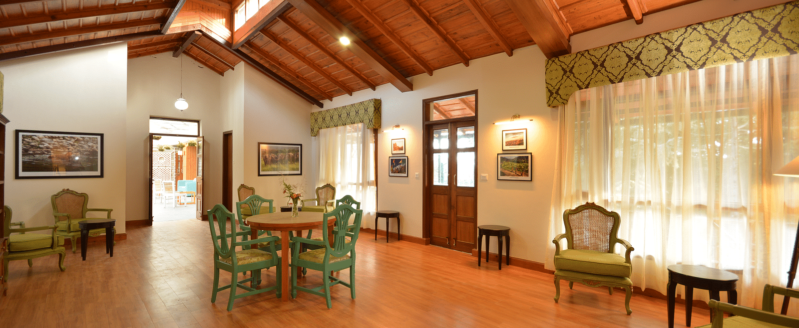 A brightly-lit hall in Almora with vintage-style furnishings and large windows - BluSalzz Escapade - Anant Rasa Resort