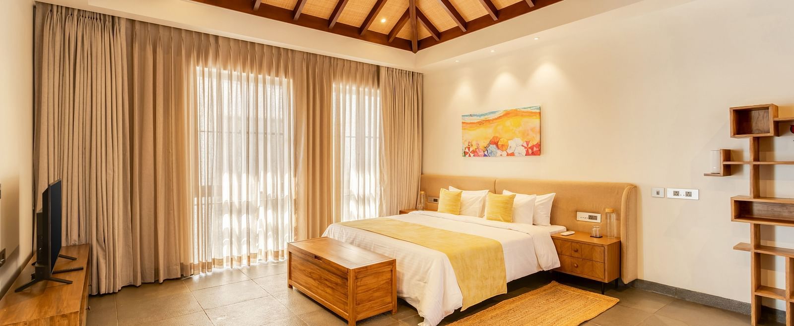 A bright and airy bedroom with a pitched ceiling, a king-sized bed, and soft, neutral tones creating a serene atmosphere - BluSalzz Villas - Alocassia, Anjuna