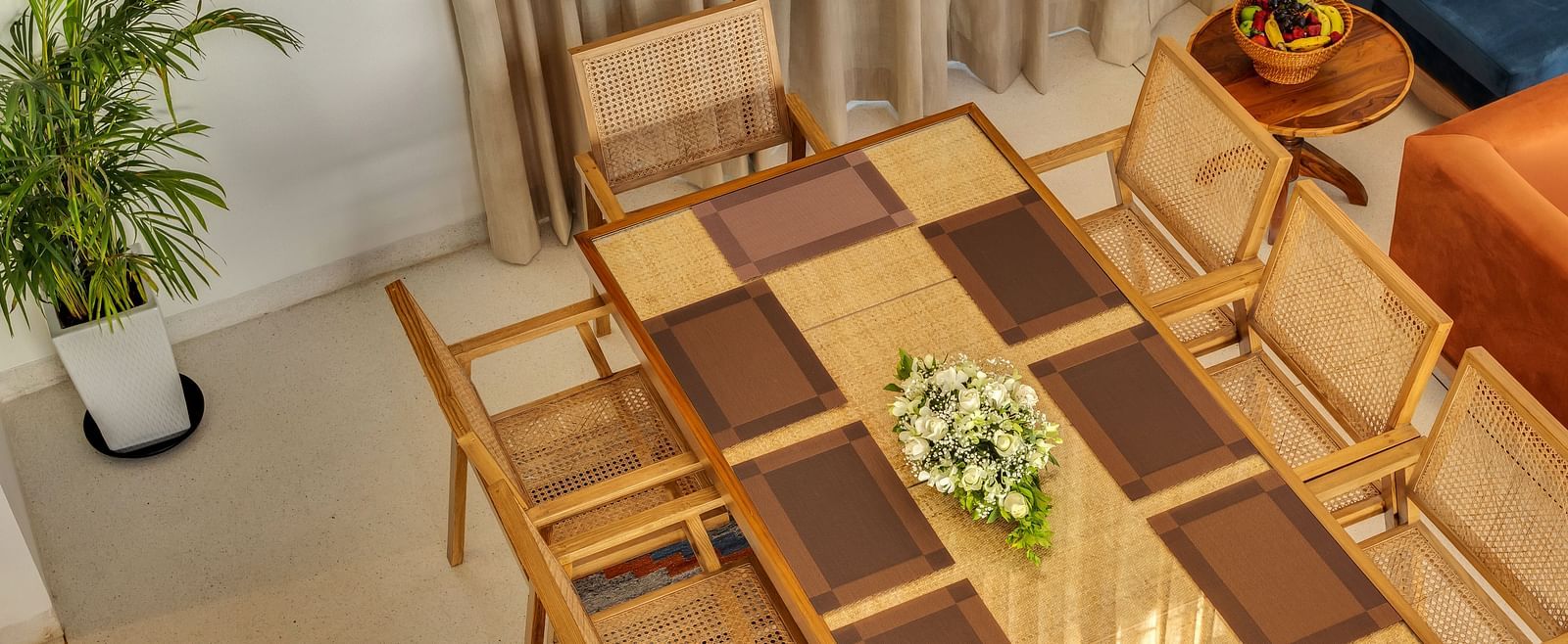 A close-up view of a neatly set dining table with contemporary decor and elegant arrangements - BluSalzz Villas - Alocassia, Anjuna