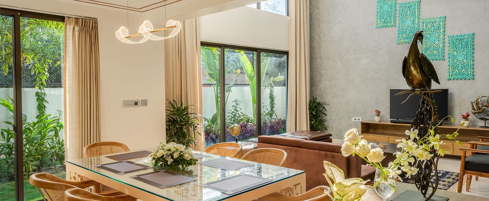 A contemporary dining area featuring a large wooden table, stylish chairs, and abundant natural light streaming through the windows.