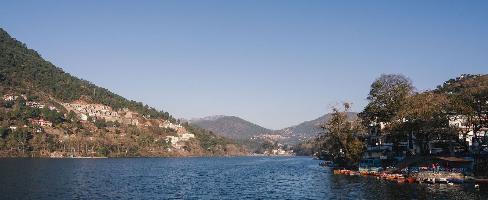 BluSalzz Villas - The Green Roof, Bhimtal, offers a breathtaking lake view surrounded by majestic mountains and a pristine, clear sky.